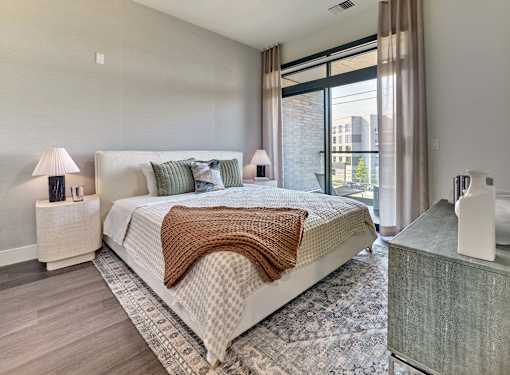 A bedroom with a large bed and a window.