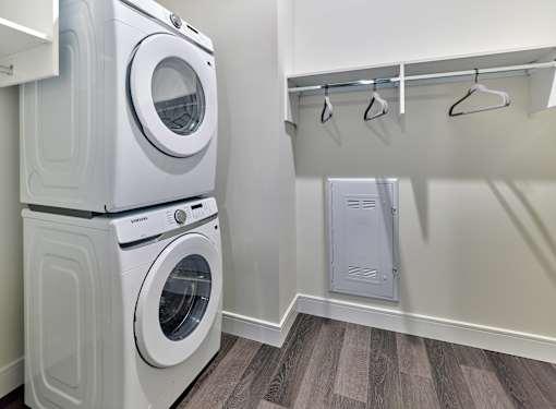 A white washing machine and dryer in a laundry room.