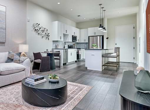 A modern kitchen with a dining table and chairs.