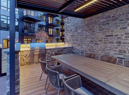 Bar and grill area in resort-style pool courtyard in a luxury apartment rental community in Paramus, NJ.