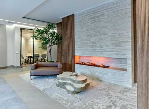 A modern living room with a fireplace and a brown sofa.
