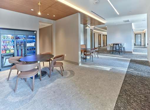 A modern dining area with a circular table surrounded by chairs.