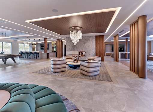 Resident clubroom with game tables and lounge and table sitting.
