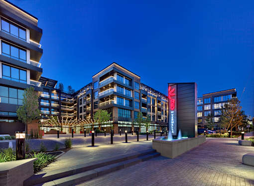 A modern building with a fountain in front of it.