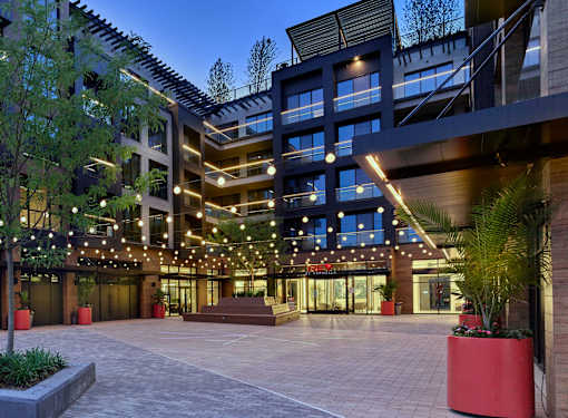 A modern building with a spacious entrance and decorative lights.