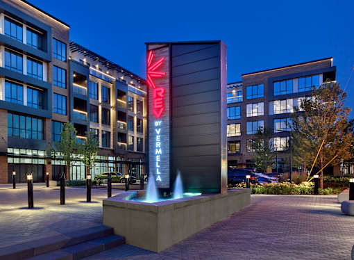 A modern building with a fountain in front of it.