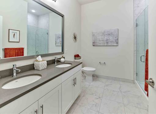 double sinks, double vanity, large bathroom, tile bathroom, glass shower door