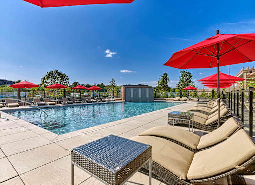 pool, sundeck, lounge chairs, patio, grills
