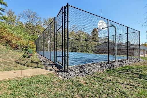 A black fence surrounds a blue pool.