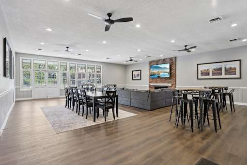 A modern dining room with a long table and chairs.