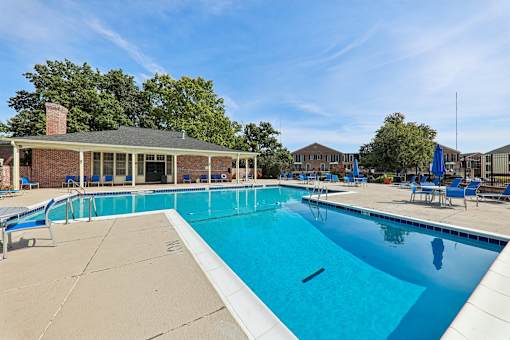 A large outdoor swimming pool two of two outside of the clubhouse at Georgetown of St. Louis Apartments
