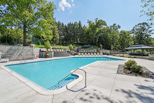 Resort-style outdoor pool and lounge area at River Oaks at Rochester Hills Apartments.