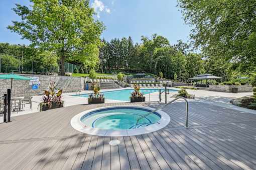 Resort-style pool and hot tub with deck seating and gazebo at River Oaks at Rochester Hills.