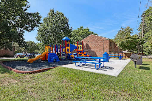 Outdoor playground and bbq area at Georgetown of St. Louis Apartments