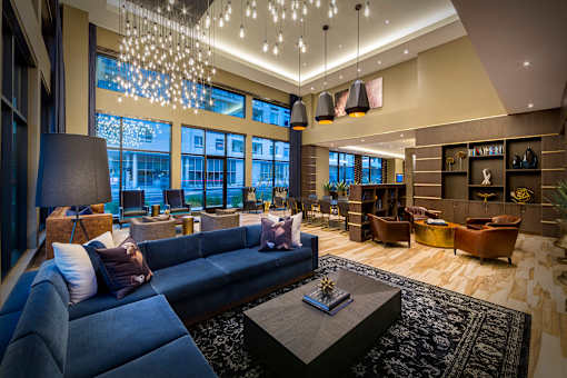 A modern living room with a large blue couch and a coffee table.