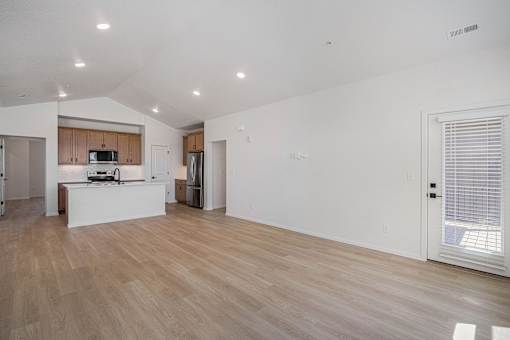 A kitchen with wooden floors and white walls.