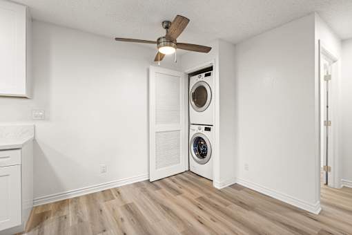 A white laundry room with a washer and dryer.