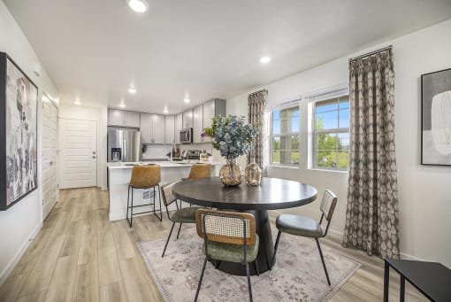 a kitchen and dining room with a table and chairs