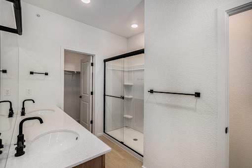 A white bathroom with a sink and mirror.