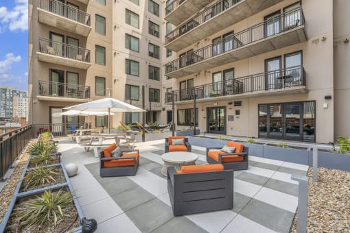 an outdoor lounge area at the bradley braddock road station apartments