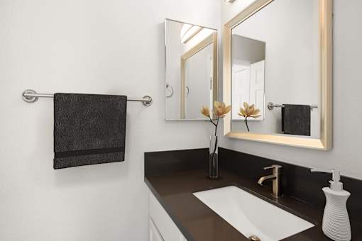 A bathroom with a white sink and a mirror.