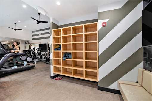 A woman is working out on a treadmill in a gym.