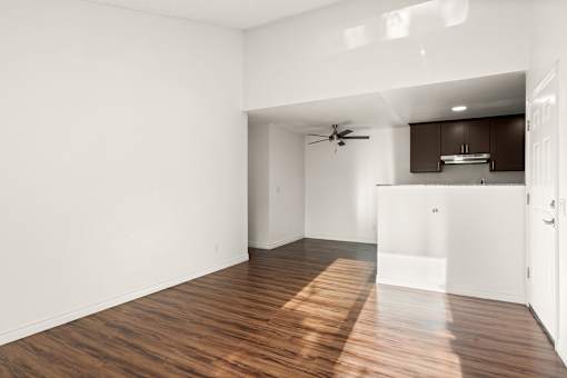 A room with wooden floors and a ceiling fan.