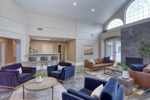 A living room with a fireplace and a large window.
