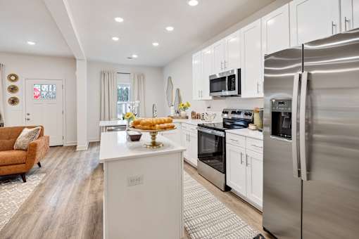 A modern kitchen with stainless steel appliances and white cabinetry