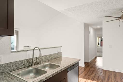 A kitchen with a sink and a window.