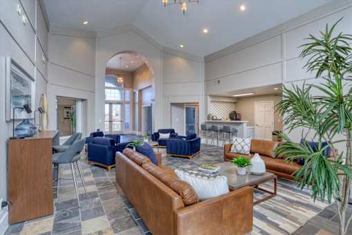 A living room with a brown couch and a blue chair.