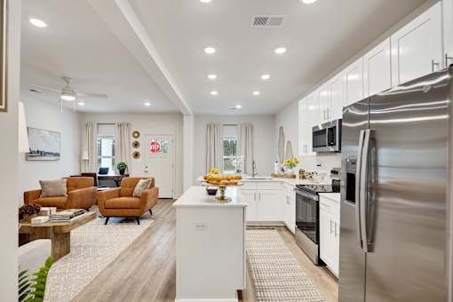 A modern kitchen with a refrigerator on the right side.