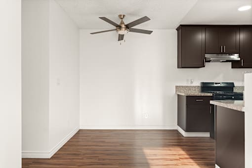 A kitchen with a fan and a dishwasher.