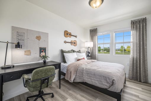 a bedroom with a bed and a desk