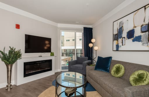 a living room with a fireplace and a couch and a glass coffee table