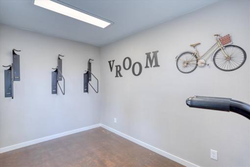 A room with a bicycle and VR equipment.