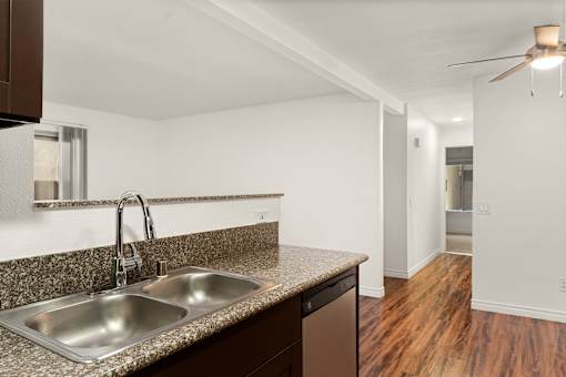 A kitchen with a sink and a window.