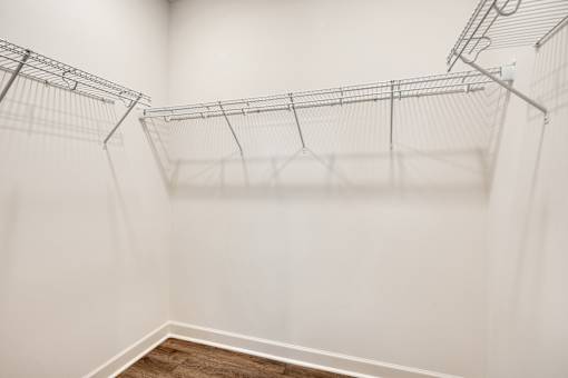 Empty wire shelves in a white room.