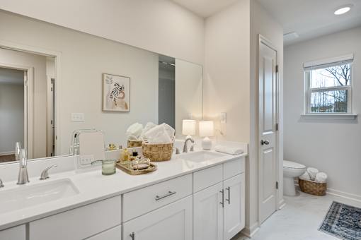 A bathroom with two sinks and a large mirror.