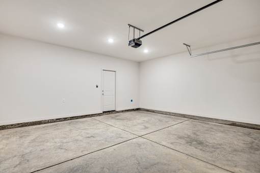 A white room with a door and a black line on the ceiling.
