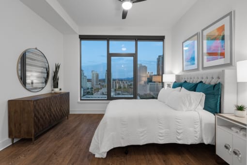 a bedroom with a large bed and a large window at Stanza Little Italy, San Diego, CA, 92101