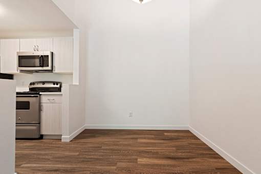 A kitchen with a microwave and oven built into the cabinetry.