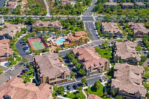 A neighborhood with houses and a tennis court.