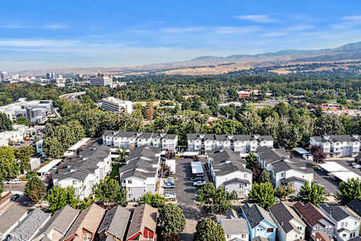 A bird's eye view of a residential area with houses and cars.