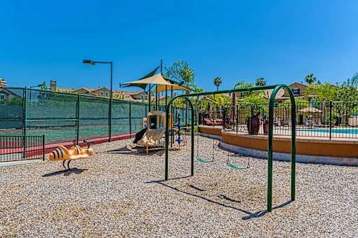 A playground with a swing set and a slide.