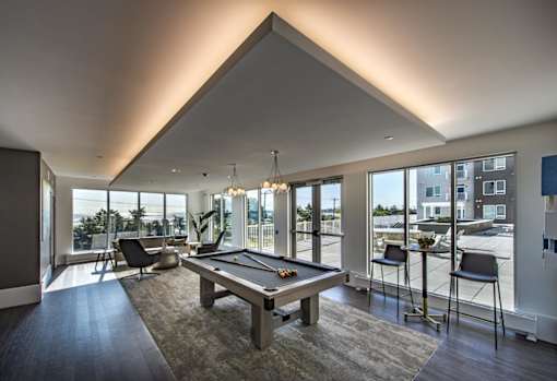 clubhouse with pool table, lounge seating, and with ocean views