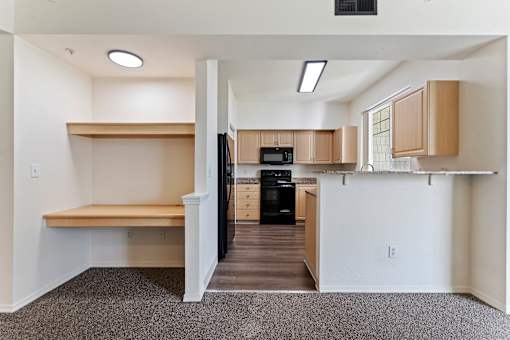A kitchen area with a refrigerator, oven, and microwave.