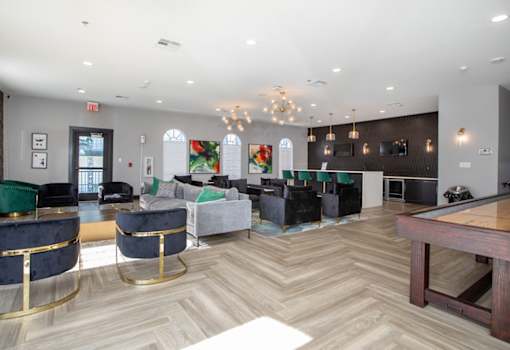 A room with a pool table and a bar.