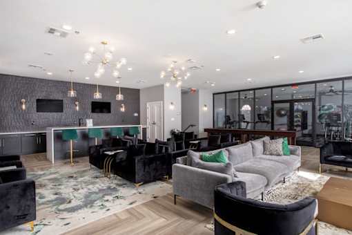 Leasing office with black and grey furniture and a wooden floor.