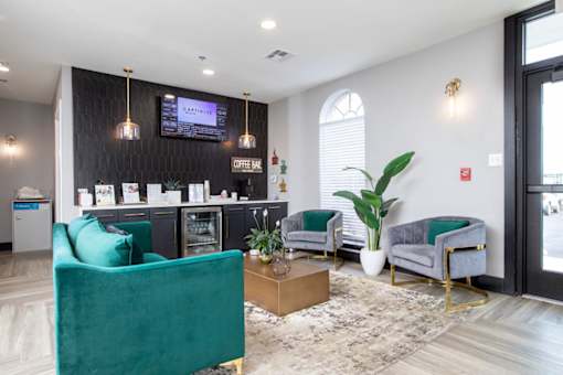 Leasing office with a green chair and a brown coffee table.
